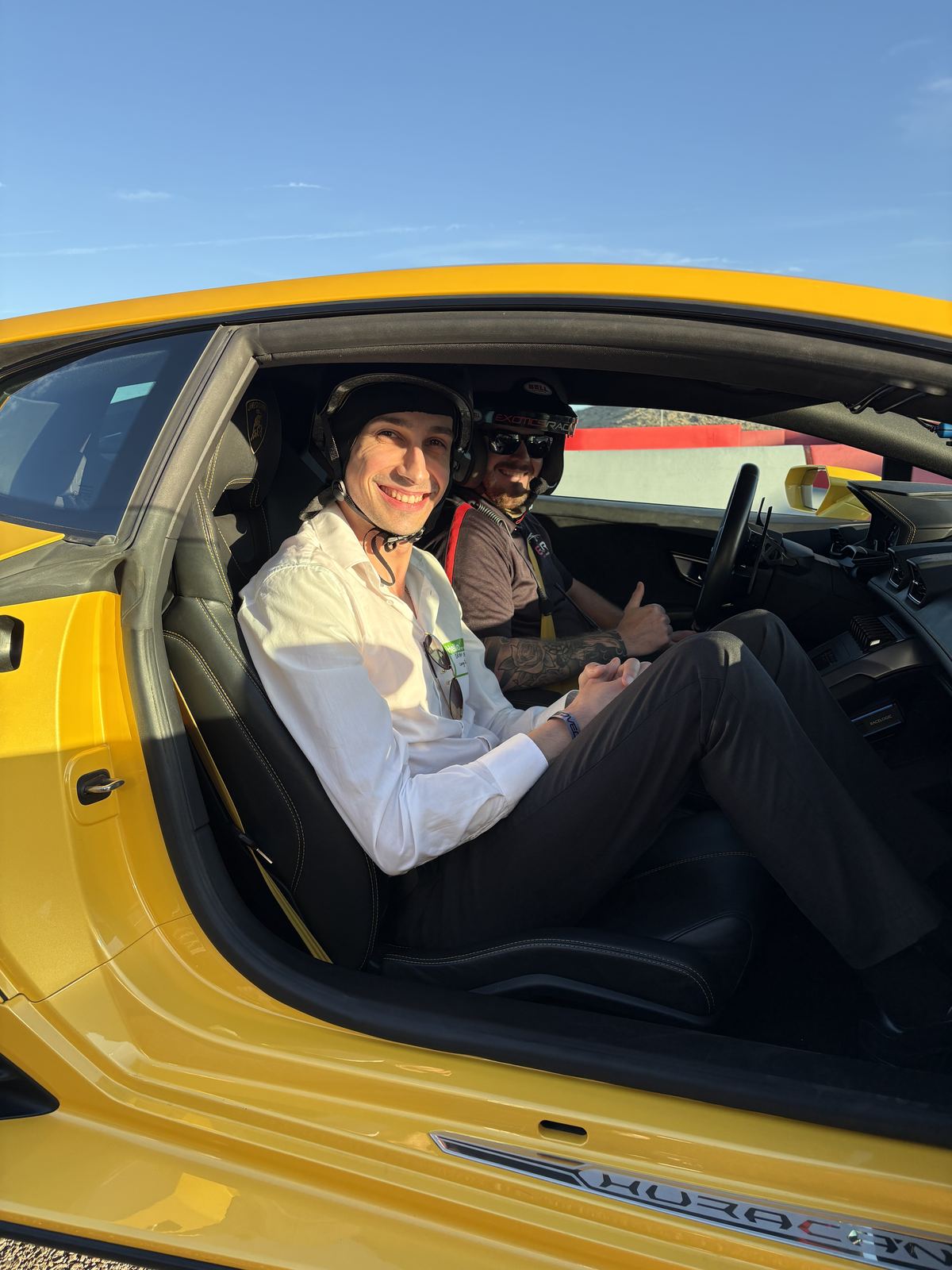 Bryan Zagury smiling in a yellow Lamborghini Huracan at Speed Vegas